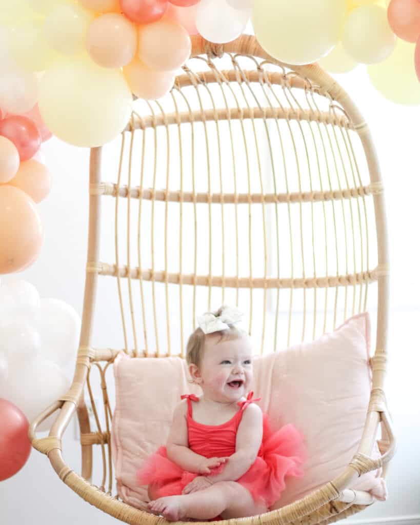 baby girl in plum tutu on her first birthday