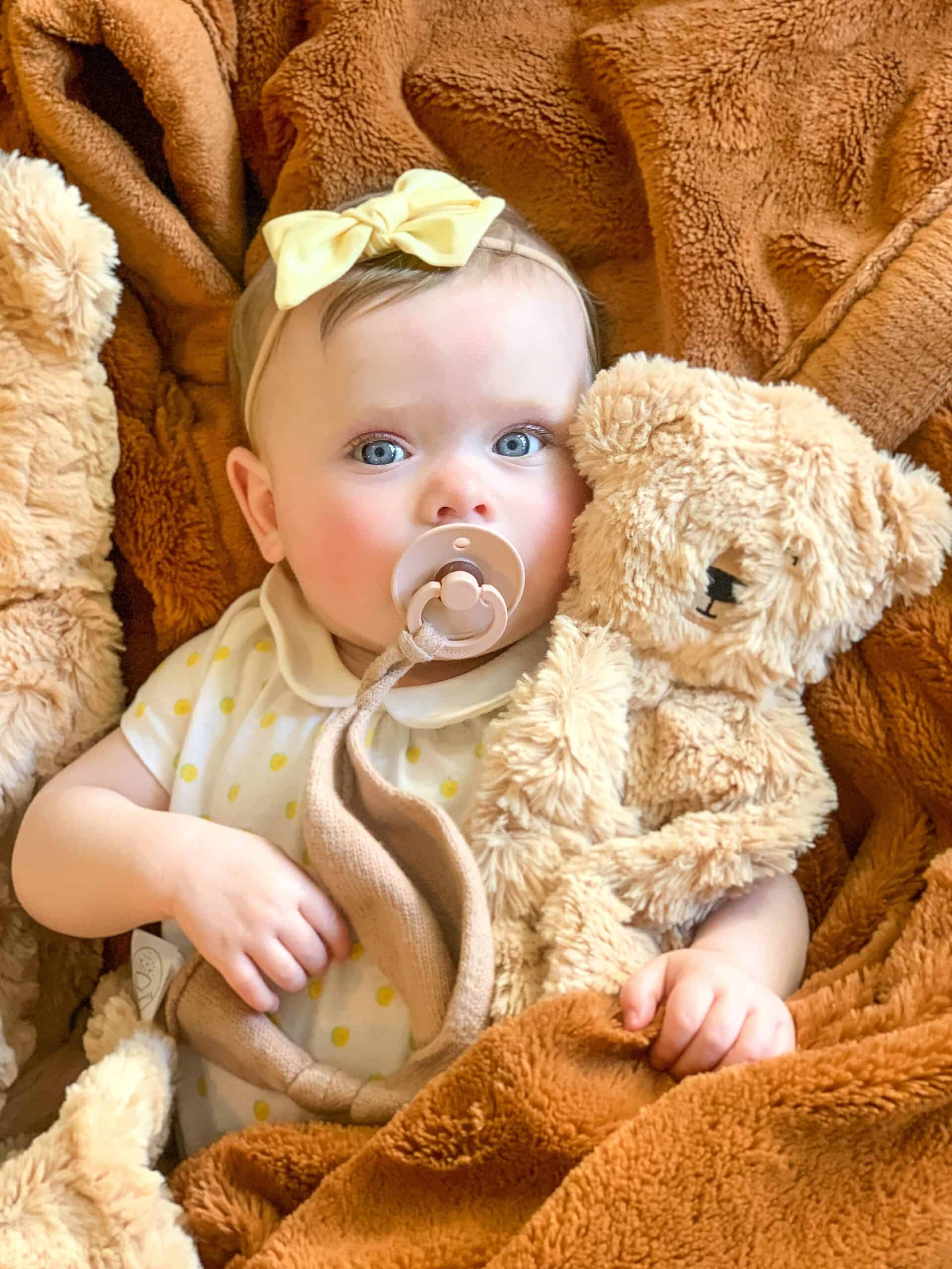 baby girl with honey bear slumberkins