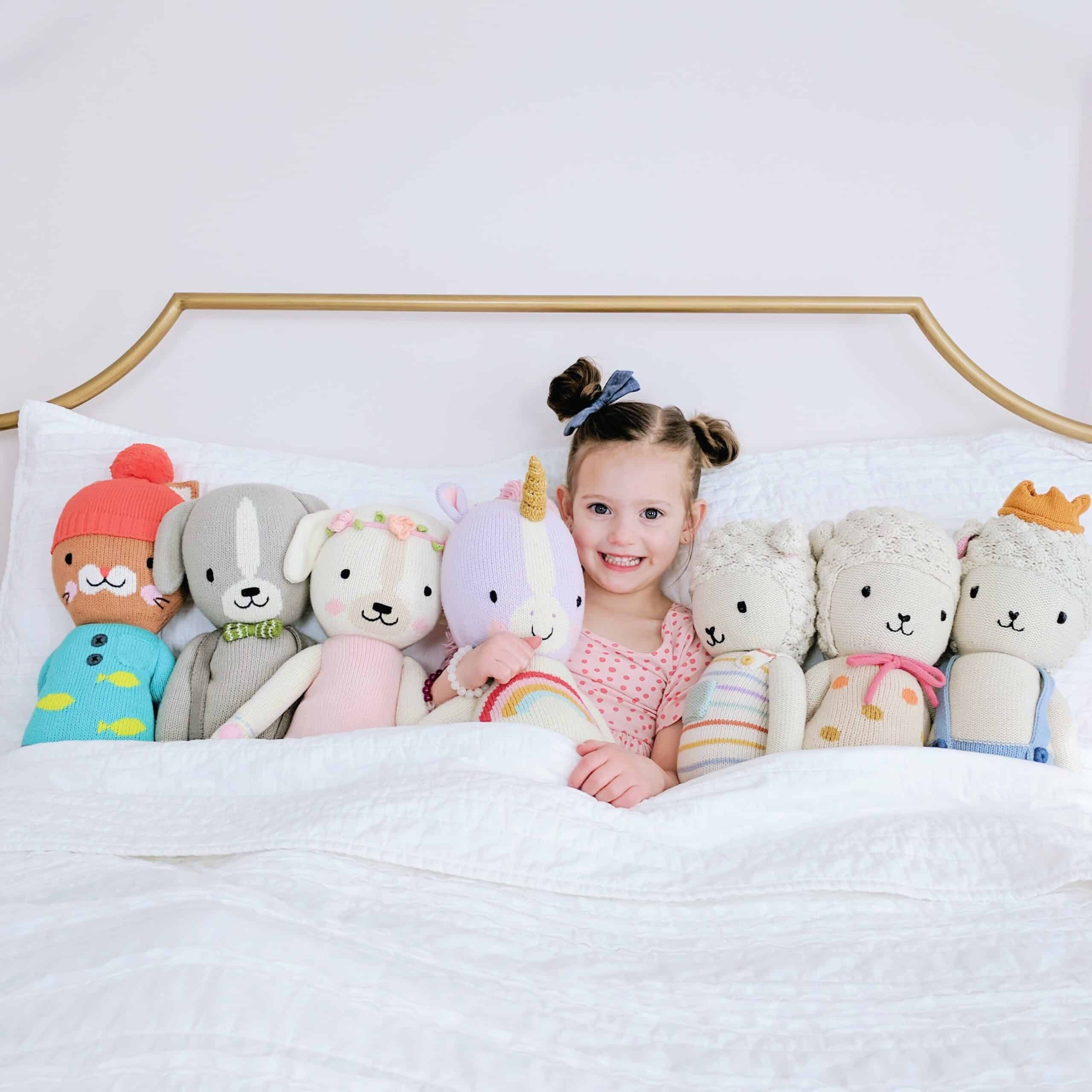 little girl with cuddle and kind dolls 