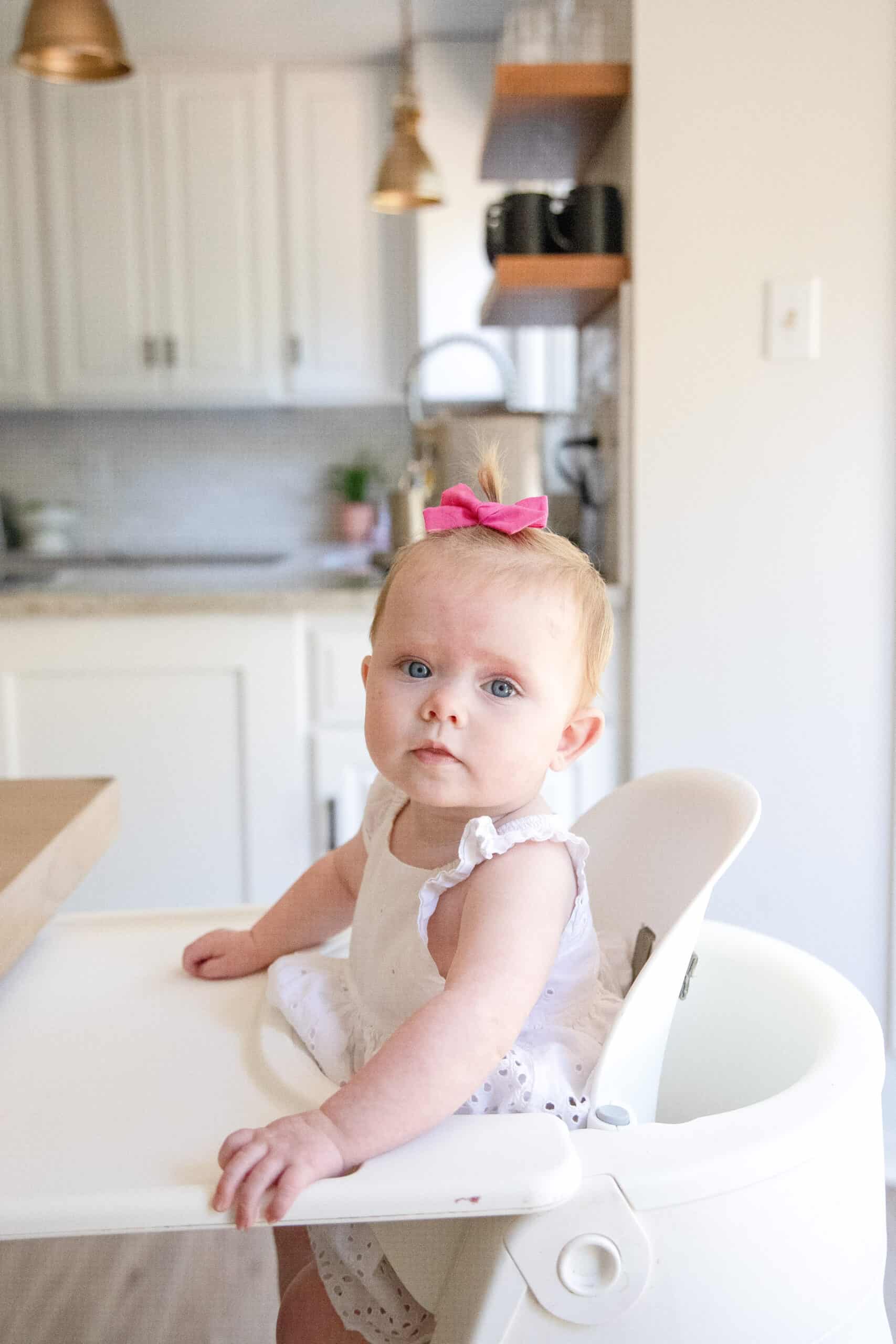 baby girl in stokke highchair