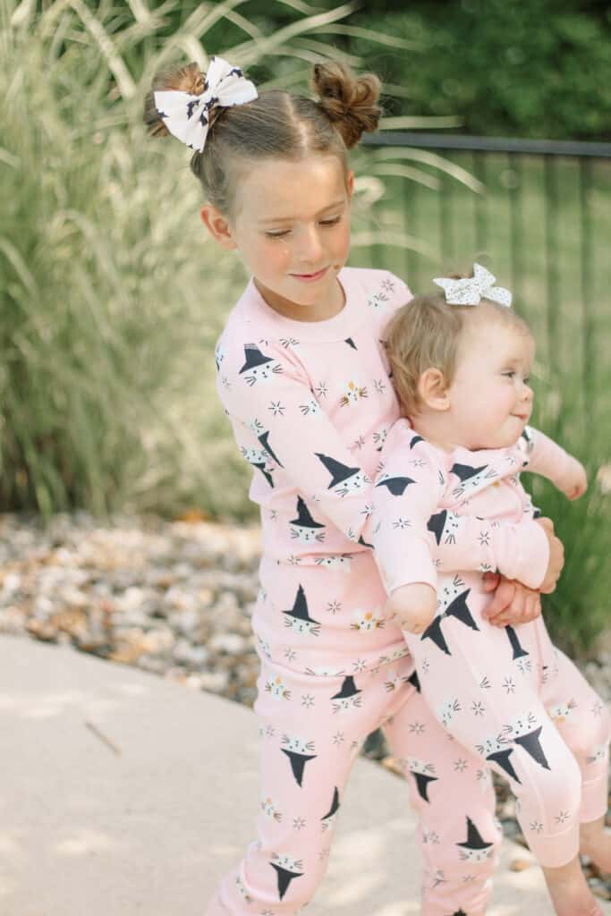 sisters in pink halloween pajamas 