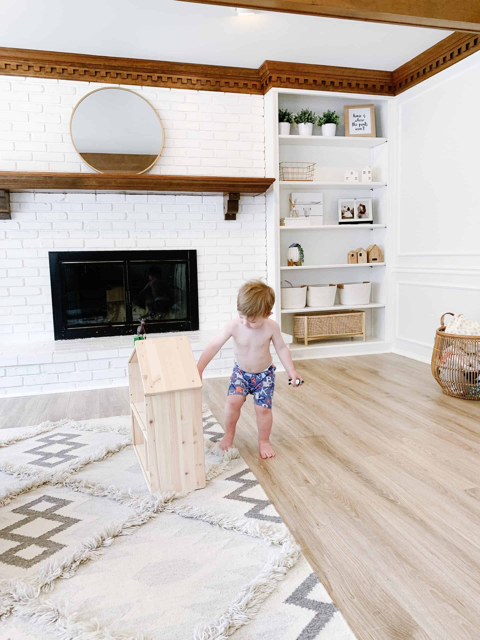 toddler boy with Ikea doll house