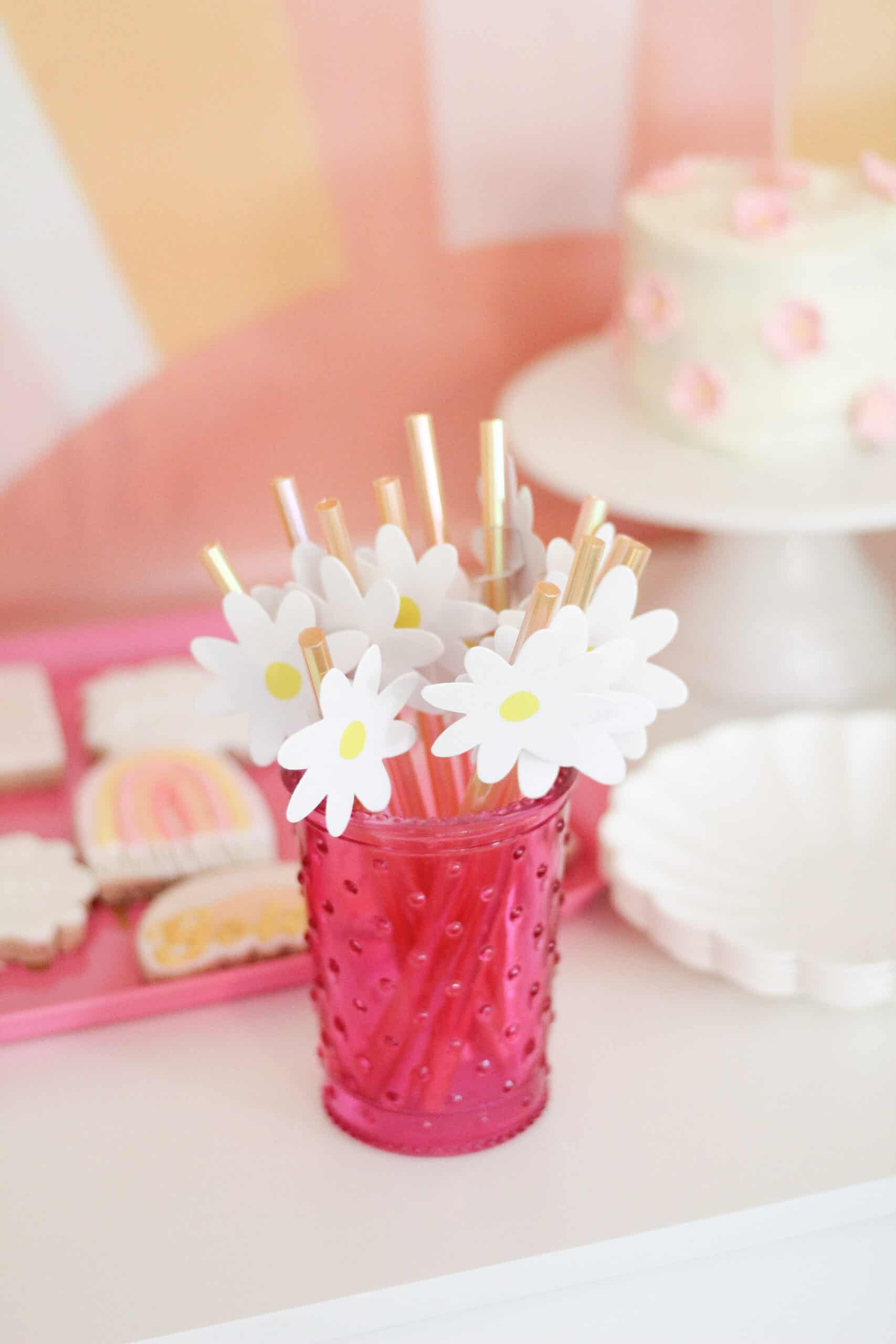 pink cup with yellow daisy straws