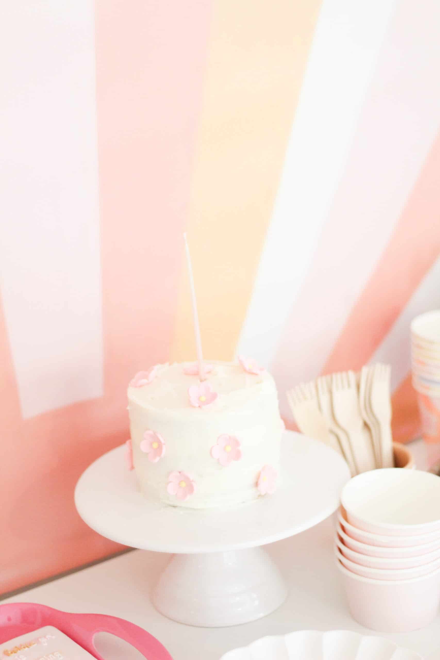 smash cake with pink and yellow flowers