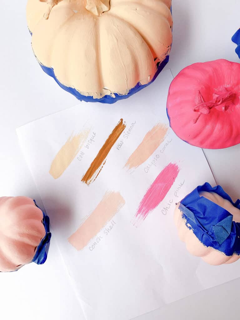 pink color block pumpkins being painted