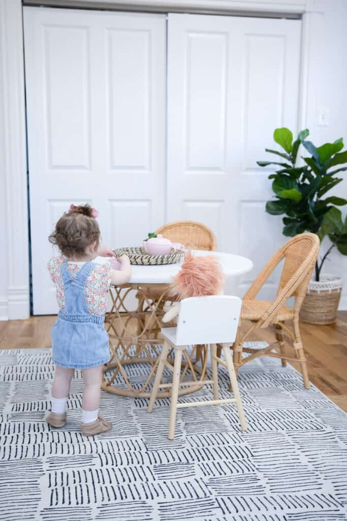 toddler girl by kids table 