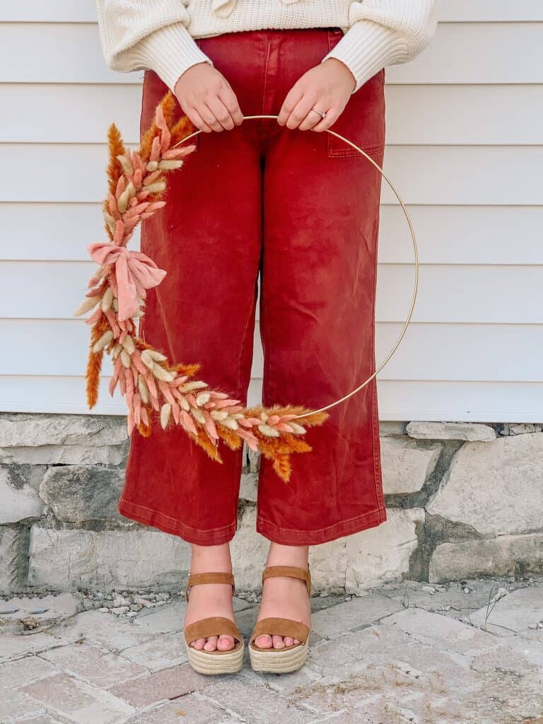 woman holding simple bunny tail Diy fall wreath