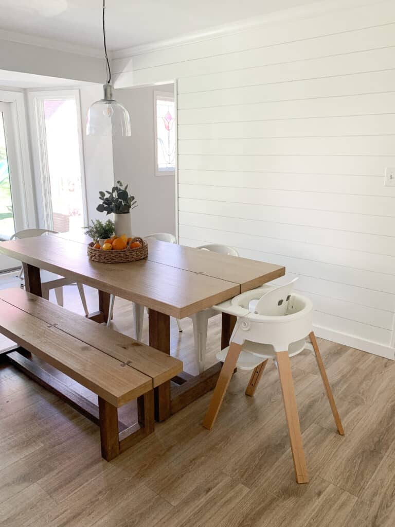 kitchen with shiplap wall and stokke highchair 