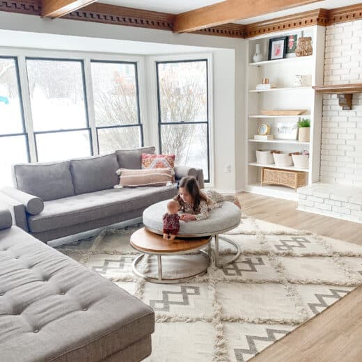 little girl on ottoman at house