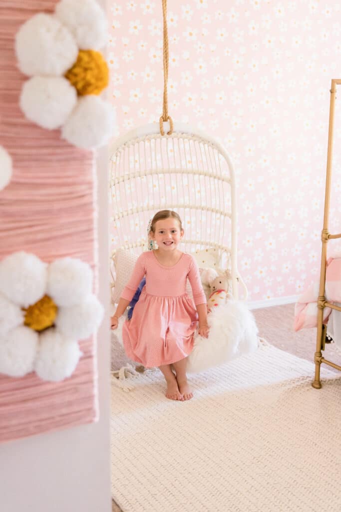 little girl in Serena and lily hanging chair 