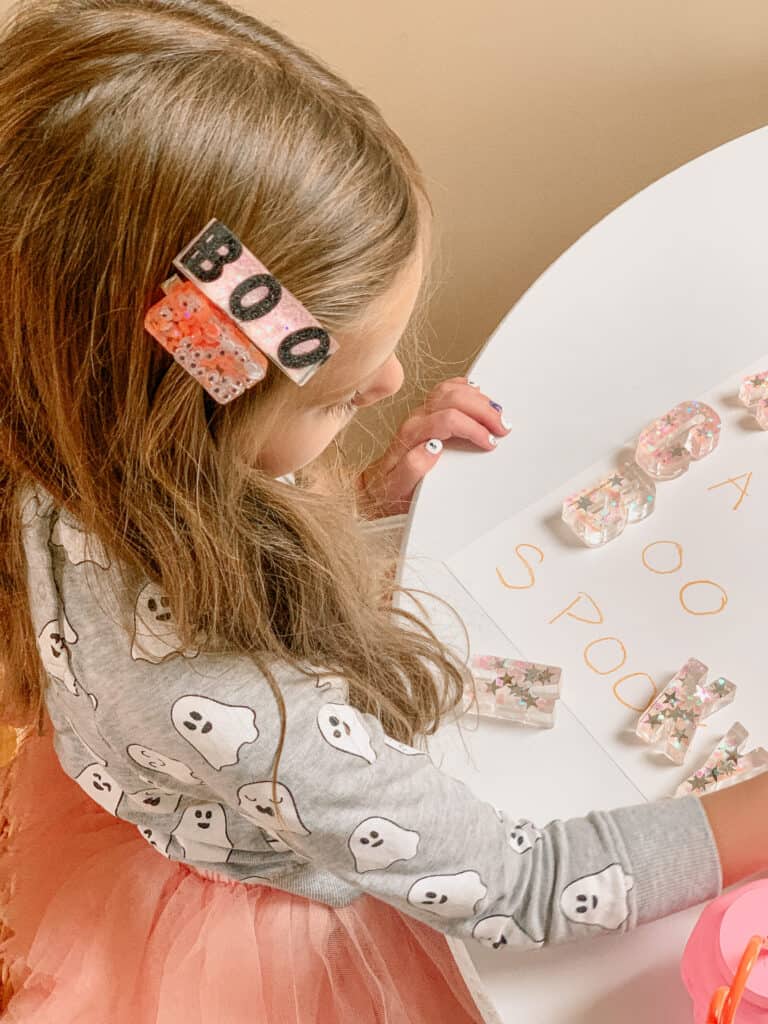 little girl playing with Resin Glitter Letters