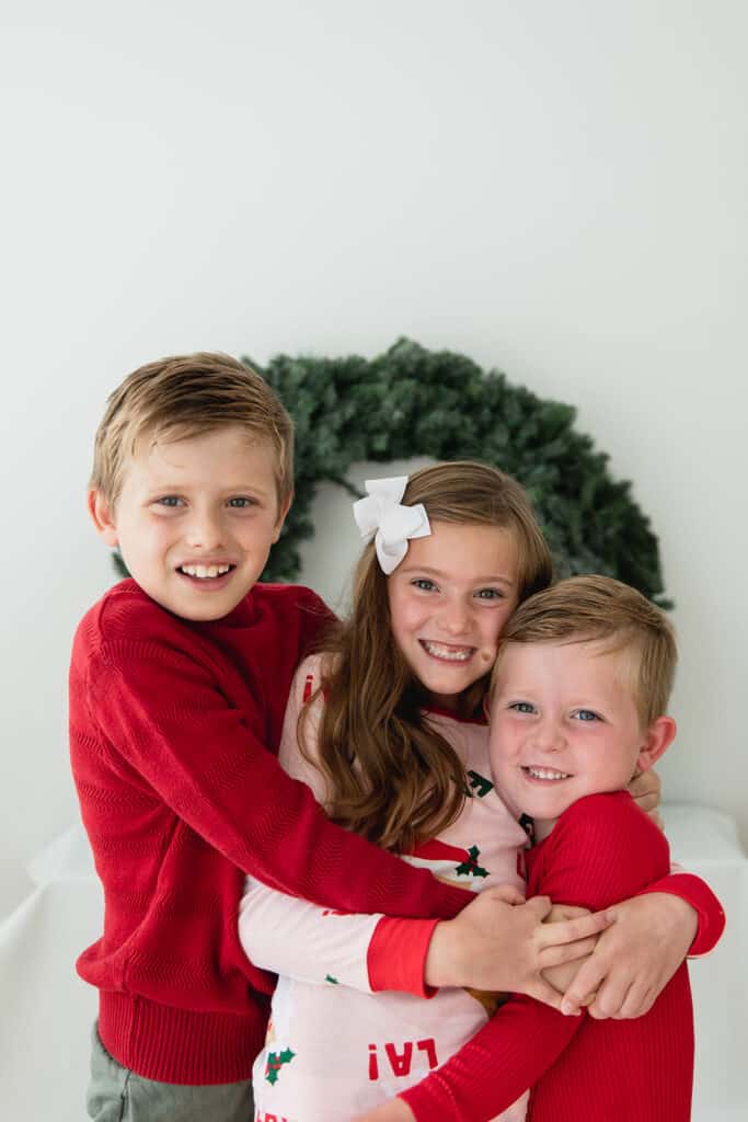 siblings in matching family Christmas Pajamas