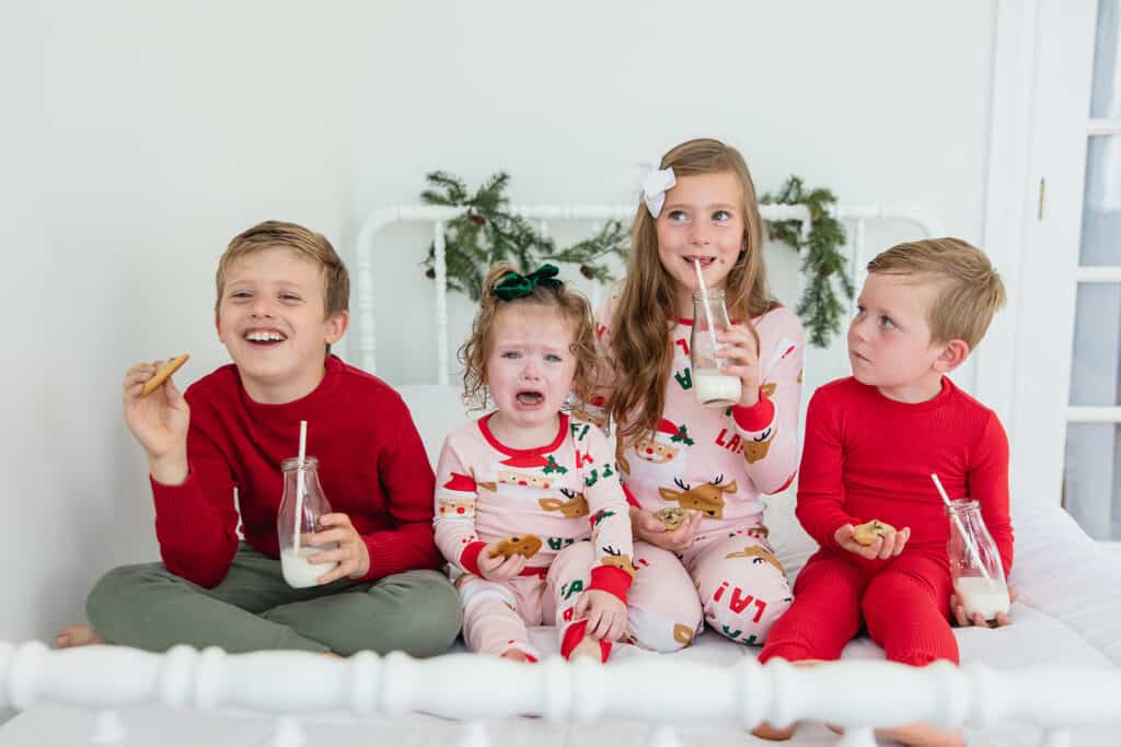 Matching family Christmas pajamas on siblings 