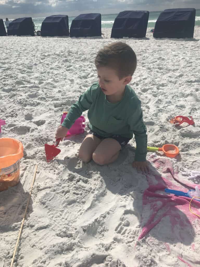 4 year old boy playing on the beach