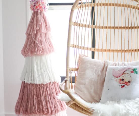 DIY Pink yarn Christmas tree next to Serena and lily chair