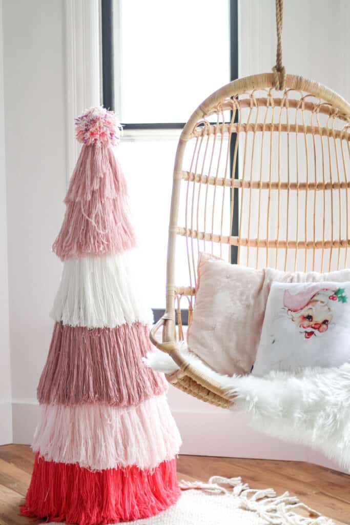 DIY Pink yarn Christmas tree  next to Serena and lily chair