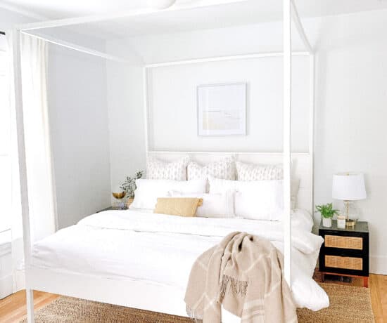 master bedroom with white bedding and white canopy bed