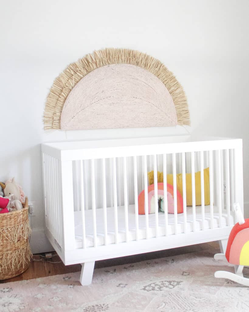 nursery with large pink sunshine on wall