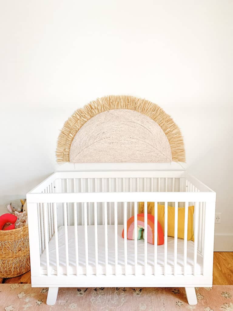 crib with large sunshine over it 