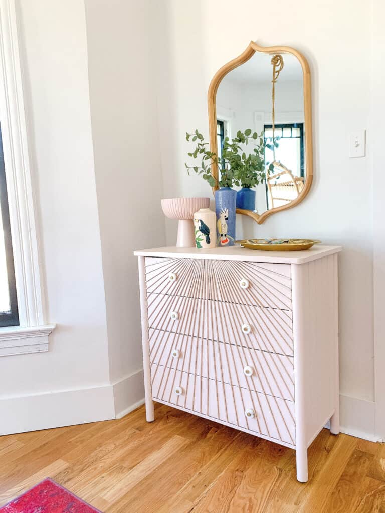 pink dresser with wood dowels 