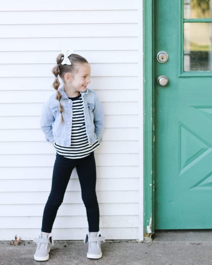 little girl against shed