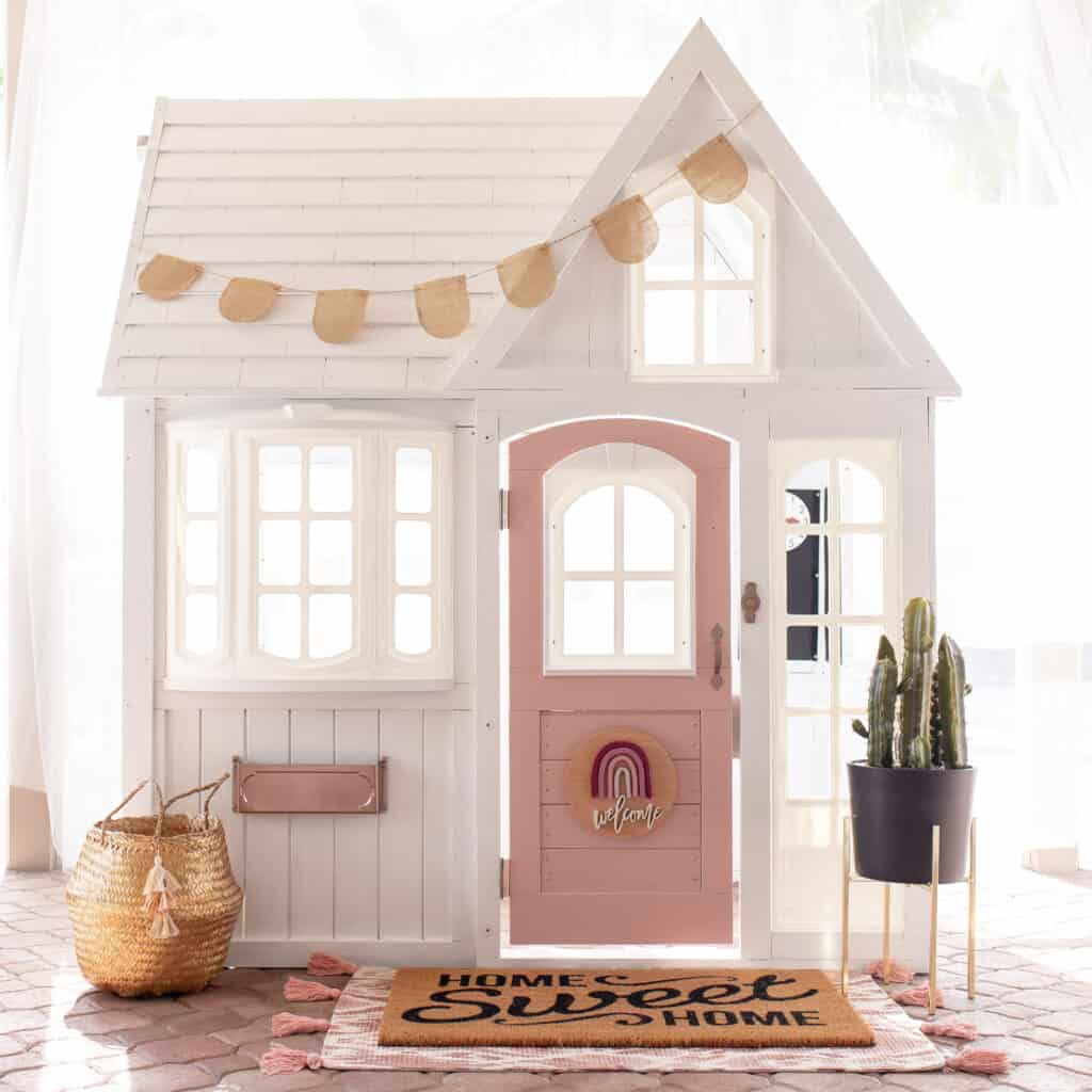 outdoor playhouse with pink door