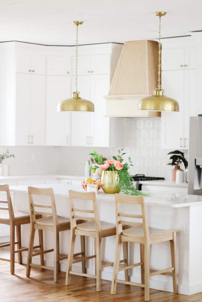 white kitchen with brass pendants 