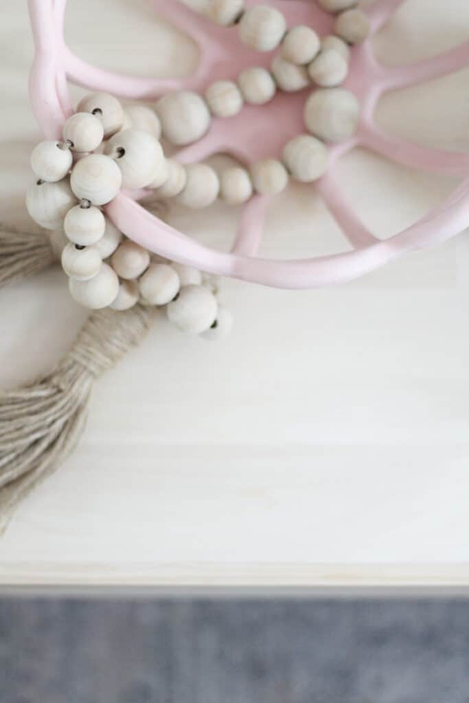 pink decorative bowl with wood beads 