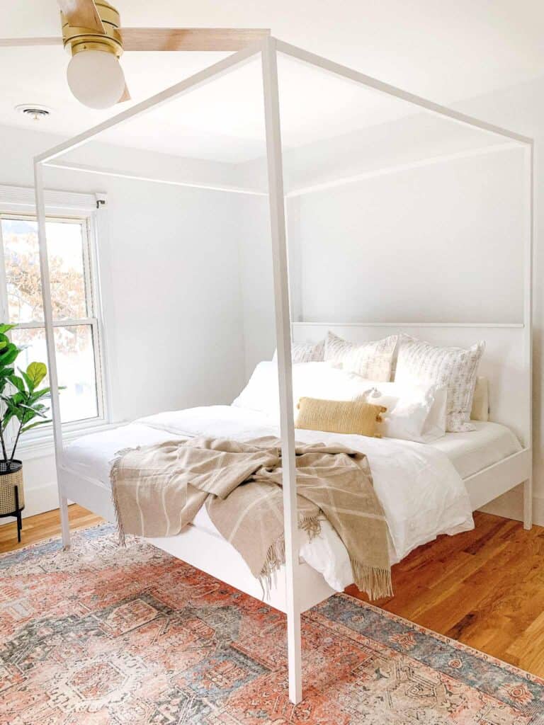 master bedroom with white canopy bed