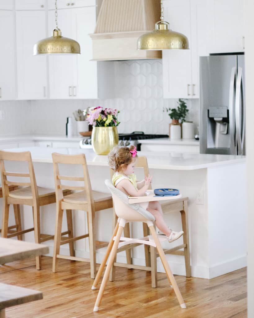 toddler girl in white kitchen 