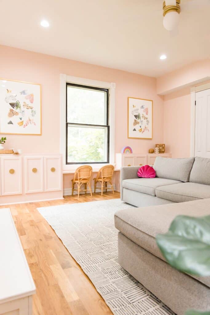 pink playroom with grey couches