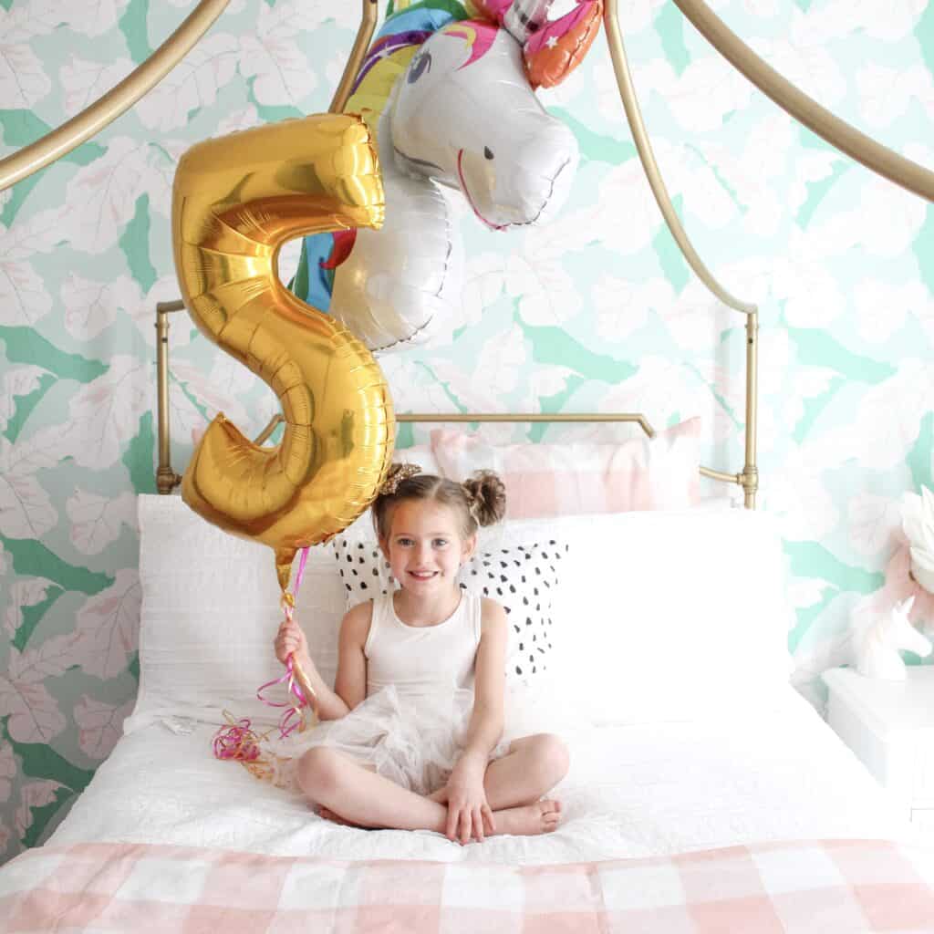 5 year old with 5 and unicorn balloon 