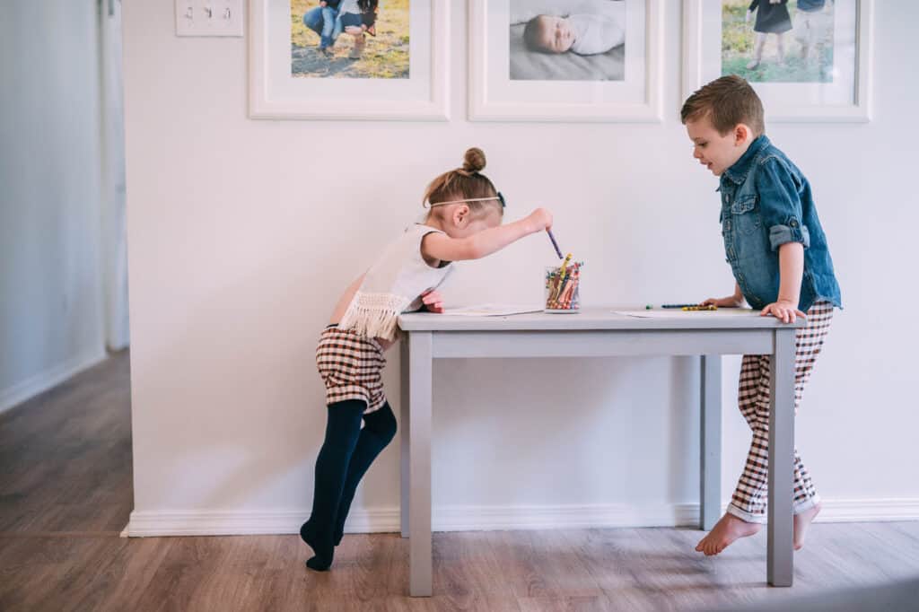 Toddlers coloring at small table 