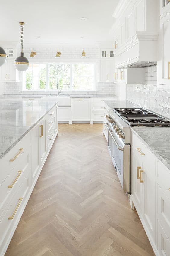 white kitchen with herringbone floors