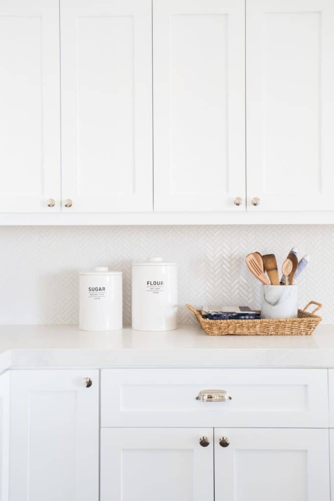 white kitchen cabinets with small white backsplash 