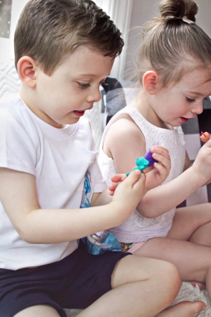 Toddlers playing with small toys