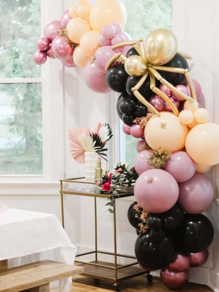 Balloon garland for Halloween over Bar Cart