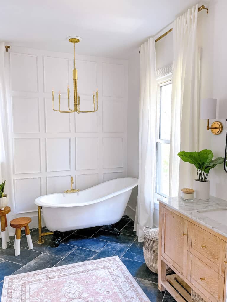 bathroom with claw foot tub and dark floors