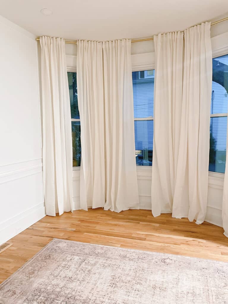 Dining room with long white curtains