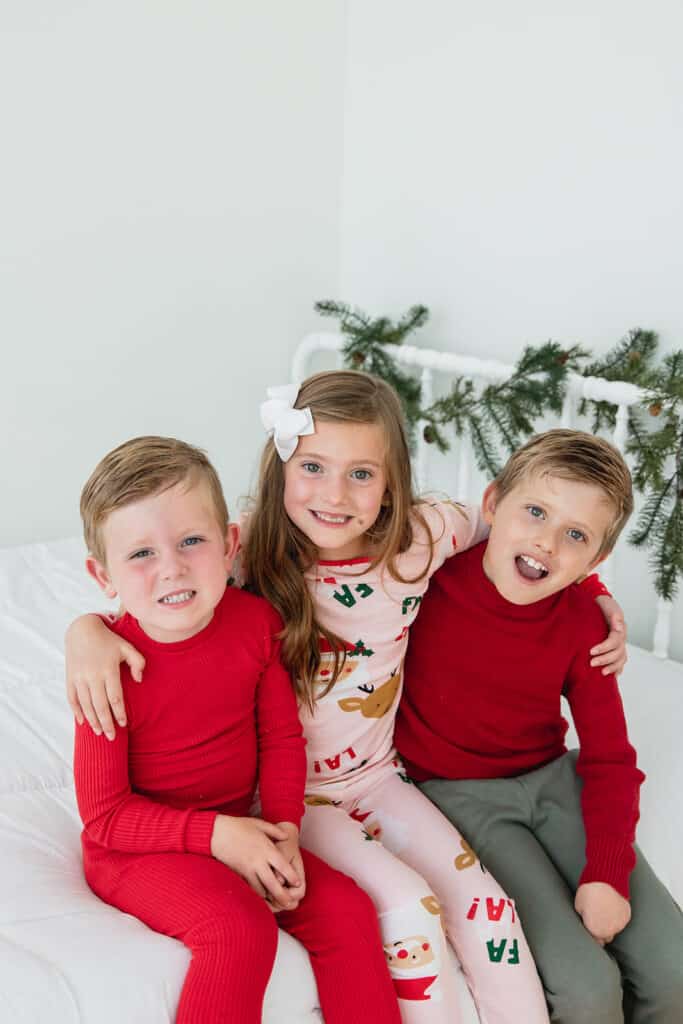 siblings in Christmas pajamas
