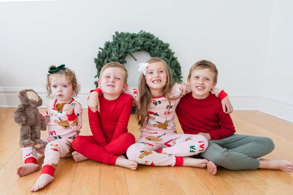 4 siblings in Christmas Pajamas 
