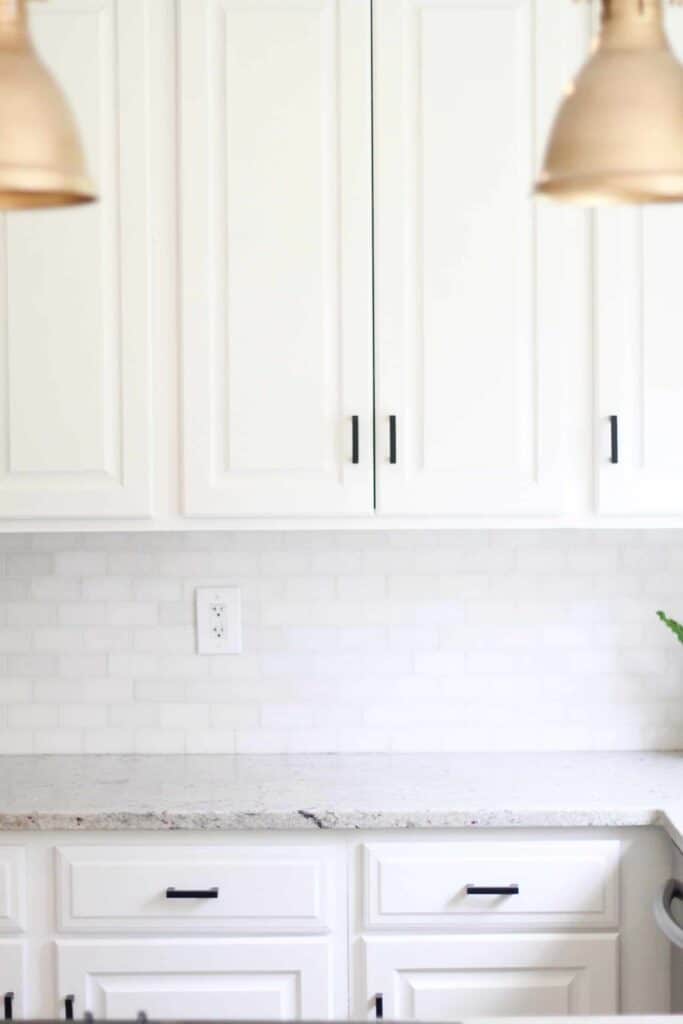 white painted cabinets with white backsplash