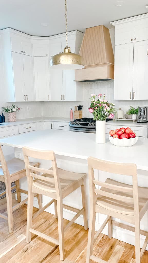White kitchen with apples on counter 