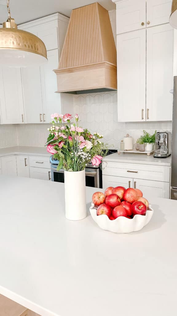 White kitchen with bowl of apples 
