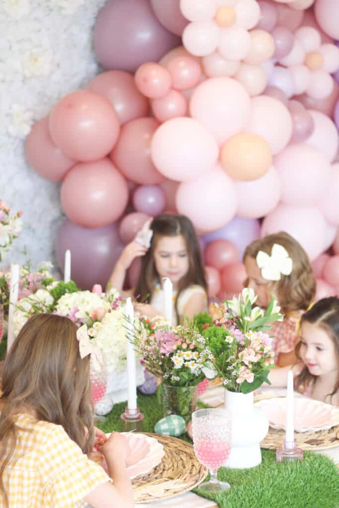 Pink floral balloons and girls at a party  