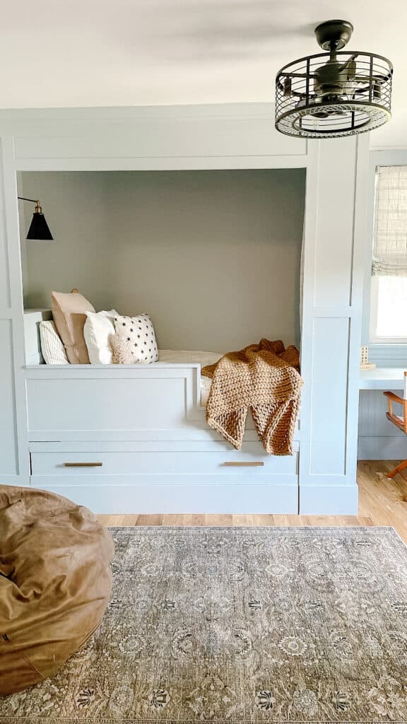 Built in bed in light blue bedroom