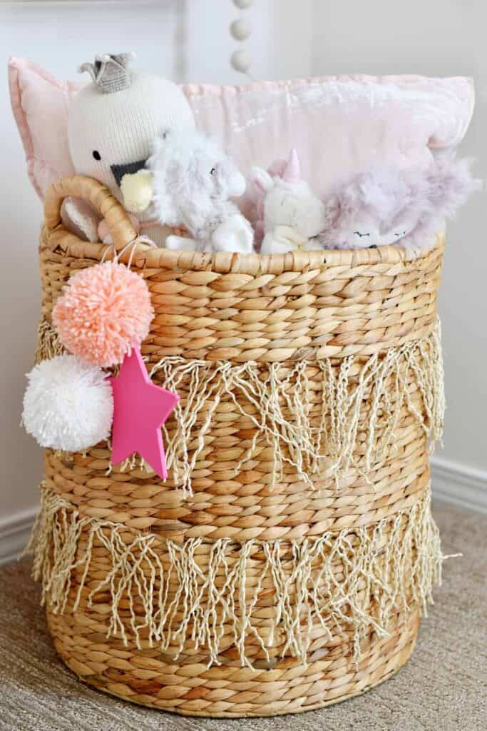 nursery decor pink pom pom and rattan basket