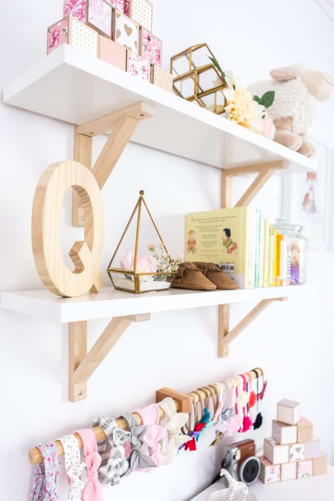 neutral girl nursery shelf decor