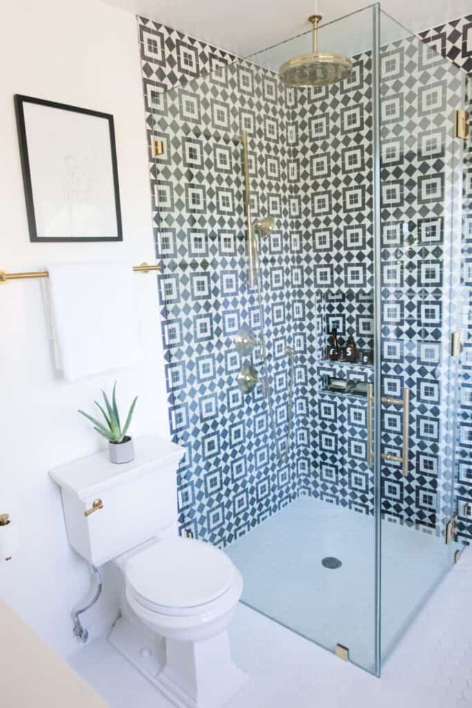 bold shower tile in crisp white bathroom