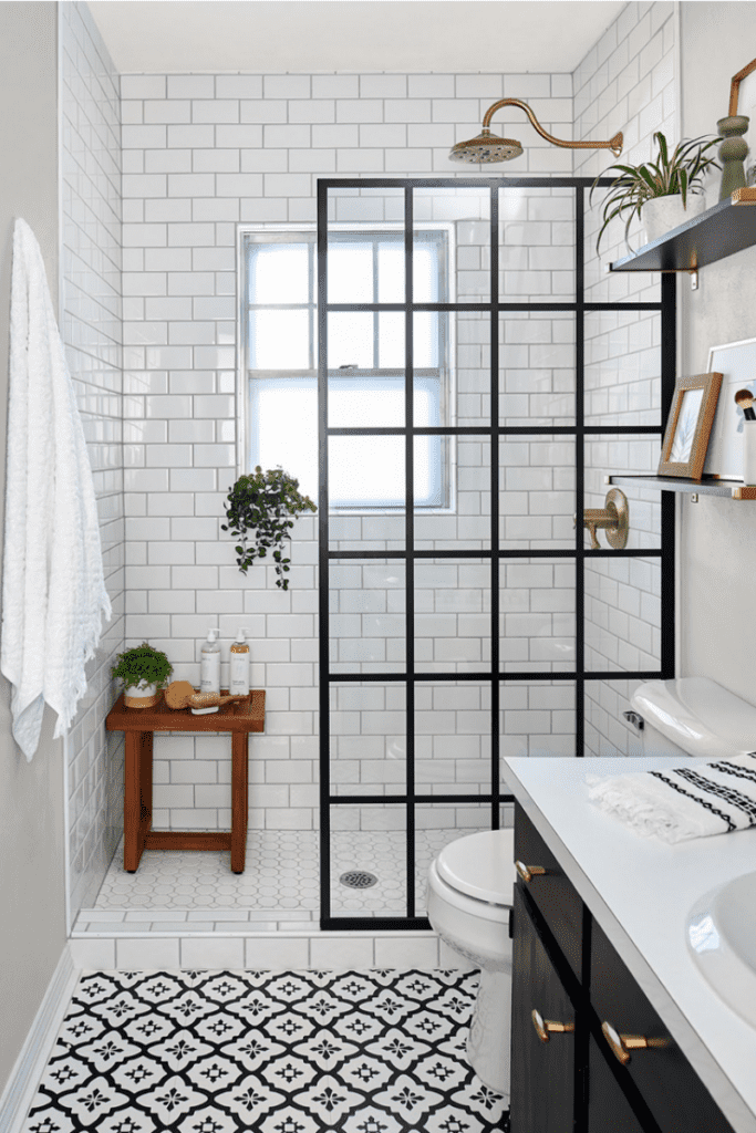 Subway tile shower wall in black and white bathroom